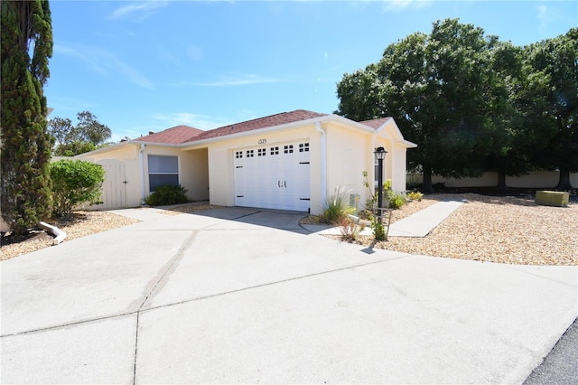 1325 Balboa Ct, The Villages, FL 32159 - ranch-style house featuring a garage, stucco siding, driveway, and a gate