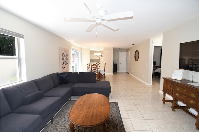 1325 Balboa Ct, The Villages, FL 32159 - living room with light tile patterned flooring, a ceiling fan, and a chandelier