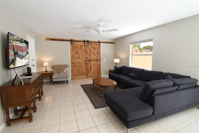 1325 Balboa Ct, The Villages, FL 32159 - living area featuring a barn door, ceiling fan, and light tile patterned floors