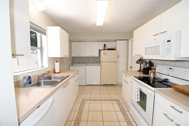 1325 Balboa Ct, The Villages, FL 32159 - kitchen with white appliances, washer and dryer, white cabinets, and light countertops