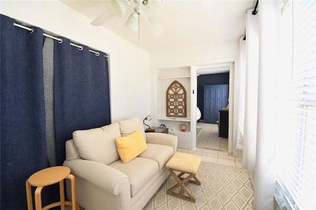 1325 Balboa Ct, The Villages, FL 32159 - sitting room featuring a ceiling fan, light tile patterned floors, and built in shelves