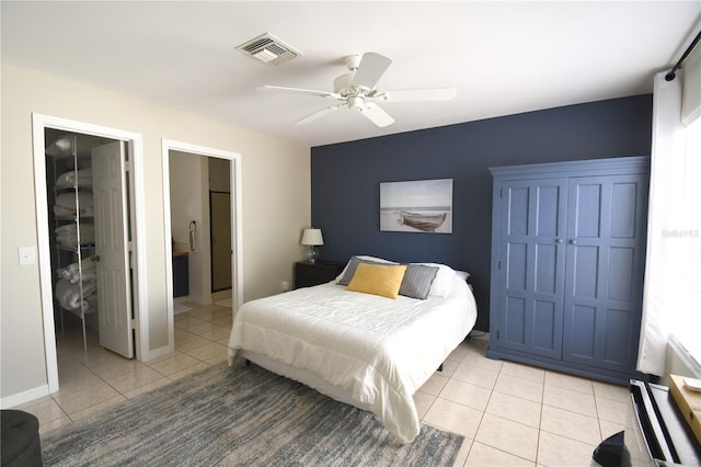 1325 Balboa Ct, The Villages, FL 32159 - bedroom with light tile patterned floors, a walk in closet, a closet, ceiling fan, and ensuite bath