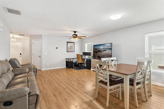 2336 Martins Run, Tavares, FL 32778 - dining space with a desk, light wood-style flooring, a ceiling fan, and a textured ceiling
