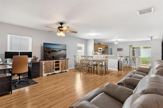 2336 Martins Run, Tavares, FL 32778 - living room with ceiling fan, light wood finished floors, plenty of natural light, and a desk