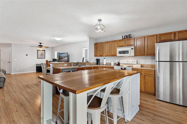 2336 Martins Run, Tavares, FL 32778 - kitchen with white appliances, butcher block counters, open floor plan, and a peninsula