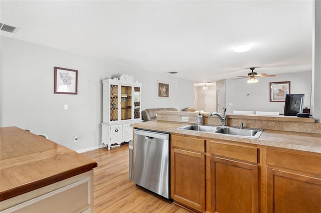 2336 Martins Run, Tavares, FL 32778 - kitchen featuring stainless steel dishwasher, light wood-style floors, a ceiling fan, brown cabinets, and light countertops