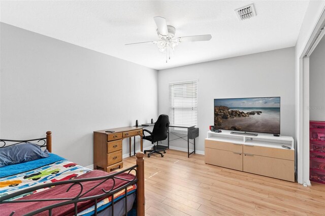 2336 Martins Run, Tavares, FL 32778 - bedroom with light wood-style floors and ceiling fan