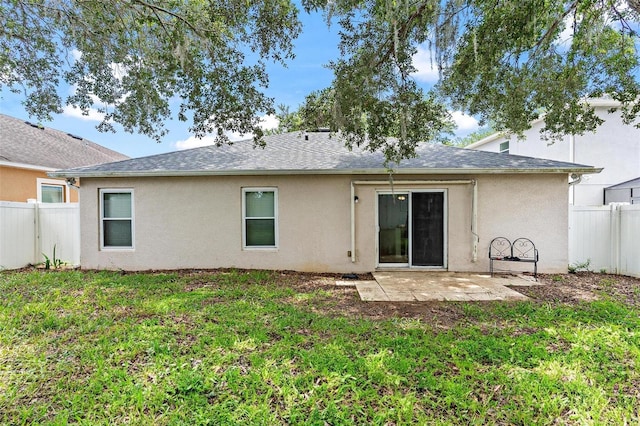 2336 Martins Run, Tavares, FL 32778 - back of property with a patio area, stucco siding, and roof with shingles