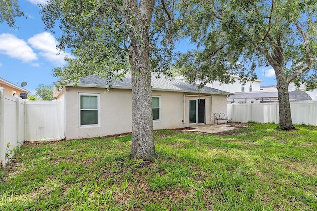 2336 Martins Run, Tavares, FL 32778 - rear view of property with stucco siding, a fenced backyard, a patio area, and roof with shingles