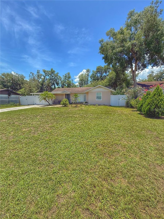 100 W Idlewild Ave, Eustis, FL 32726 - view of front of home with concrete driveway and a gate