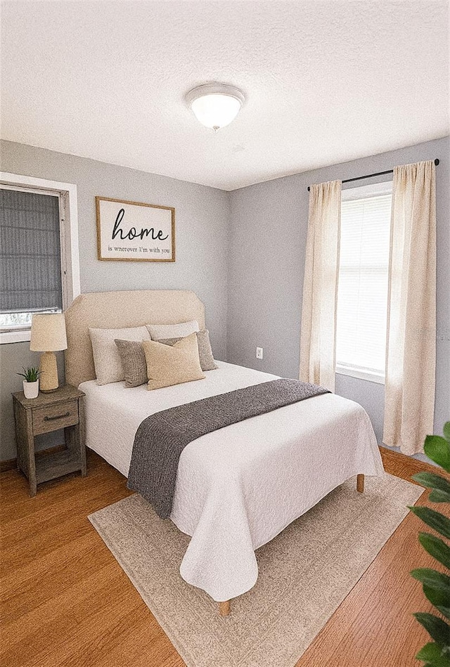 100 W Idlewild Ave, Eustis, FL 32726 - bedroom featuring wood finished floors and a textured ceiling