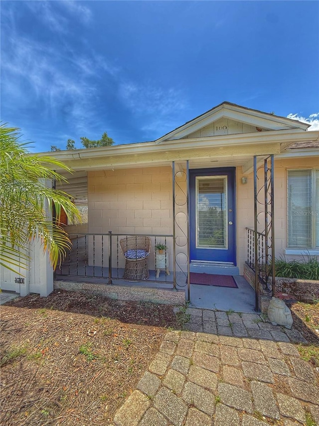 100 W Idlewild Ave, Eustis, FL 32726 - doorway to property featuring a porch and concrete block siding