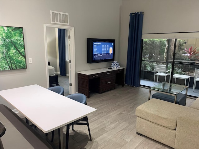 14501 Grove Resort Ave Unit 3406, Winter Garden, FL 34787 - living area with light wood-type flooring, a towering ceiling, and a desk