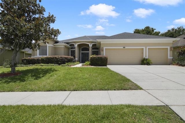 1426 Lakemist Ln, Clermont, FL 34711 - ranch-style house with a garage, concrete driveway, a front lawn, and stucco siding