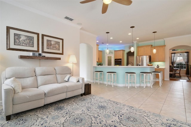 1426 Lakemist Ln, Clermont, FL 34711 - living area featuring light tile patterned flooring, ceiling fan, ornamental molding, arched walkways, and recessed lighting