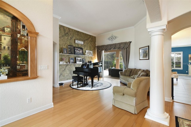 1426 Lakemist Ln, Clermont, FL 34711 - living room with decorative columns, wood finished floors, arched walkways, and crown molding