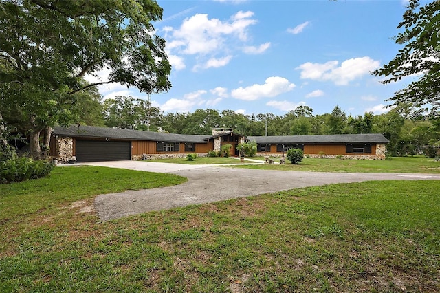 672 E Belt Ave, Bushnell, FL 33513 - view of front facade with stone siding, concrete driveway, an attached garage, and a front yard