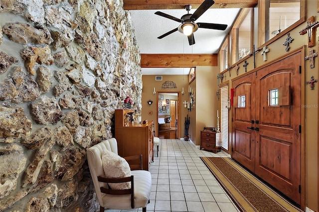 672 E Belt Ave, Bushnell, FL 33513 - foyer entrance featuring beamed ceiling, a ceiling fan, light tile patterned floors, and a textured ceiling