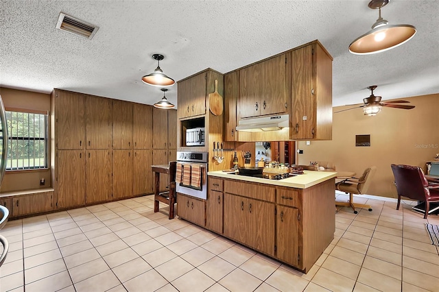 672 E Belt Ave, Bushnell, FL 33513 - kitchen with appliances with stainless steel finishes, light tile patterned flooring, light countertops, a textured ceiling, and brown cabinets