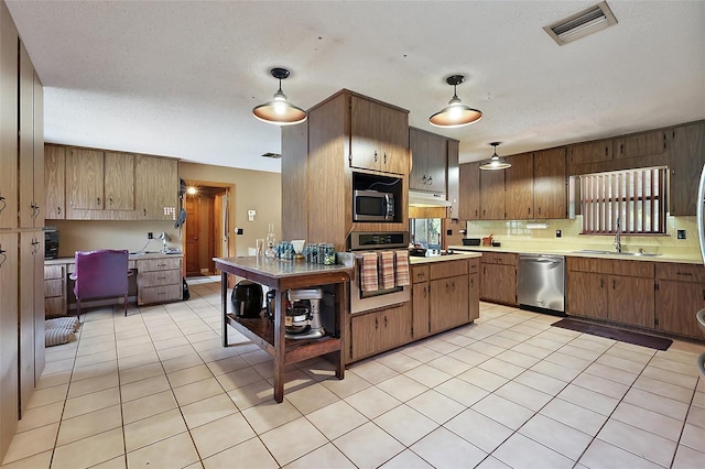 672 E Belt Ave, Bushnell, FL 33513 - kitchen with stainless steel appliances, a sink, light countertops, a desk, and light tile patterned floors
