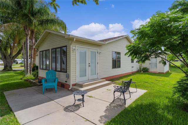 1815 Kaufman Cir, Lady Lake, FL 32159 - rear view of property with a patio area, french doors, and a yard
