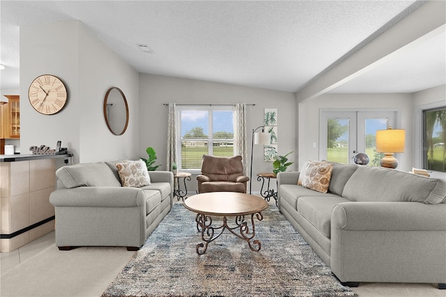 1815 Kaufman Cir, Lady Lake, FL 32159 - living area with vaulted ceiling, plenty of natural light, a textured ceiling, and french doors