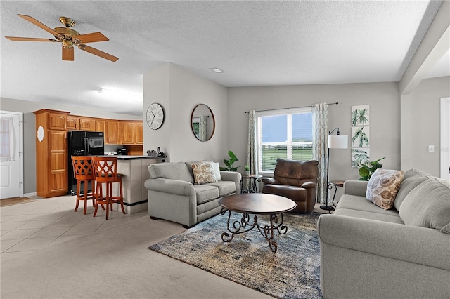 1815 Kaufman Cir, Lady Lake, FL 32159 - living room featuring lofted ceiling, ceiling fan, light colored carpet, and a textured ceiling