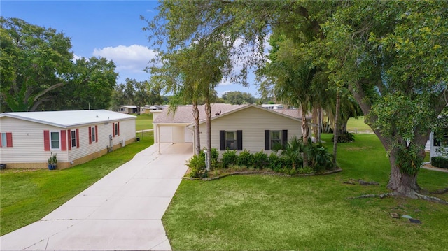 1815 Kaufman Cir, Lady Lake, FL 32159 - view of front of property with a front lawn, a detached garage, and an outbuilding