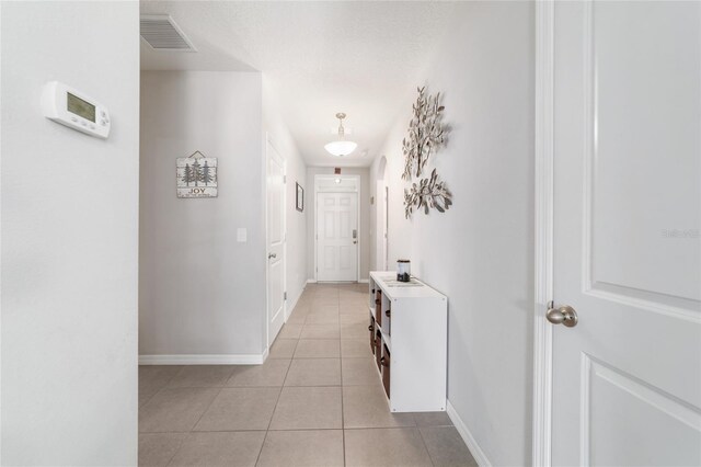 9785 Pepper Tree Trl, Wildwood, FL 34785 - hall with light tile patterned floors and baseboards