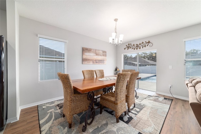 9785 Pepper Tree Trl, Wildwood, FL 34785 - dining space with a chandelier and wood finished floors
