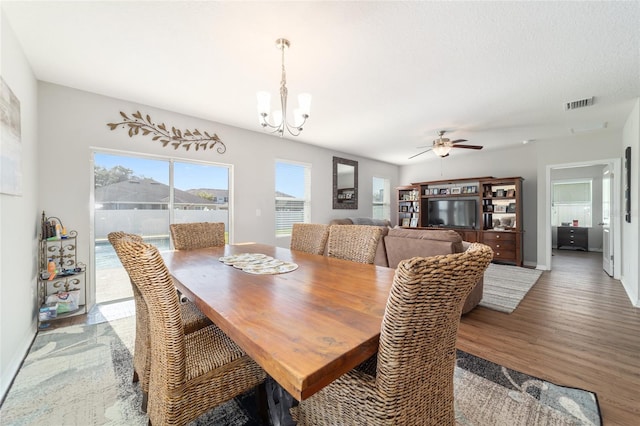 9785 Pepper Tree Trl, Wildwood, FL 34785 - dining space with a chandelier, wood finished floors, and a ceiling fan
