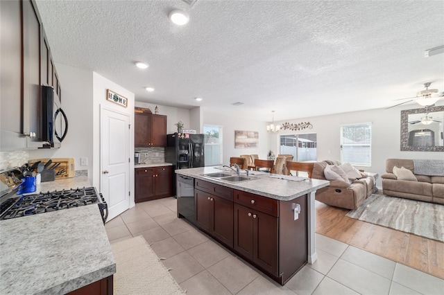 9785 Pepper Tree Trl, Wildwood, FL 34785 - kitchen with appliances with stainless steel finishes, light countertops, light tile patterned flooring, a textured ceiling, and recessed lighting