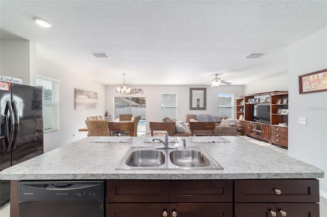 9785 Pepper Tree Trl, Wildwood, FL 34785 - kitchen with black appliances, light countertops, dark brown cabinetry, and a textured ceiling