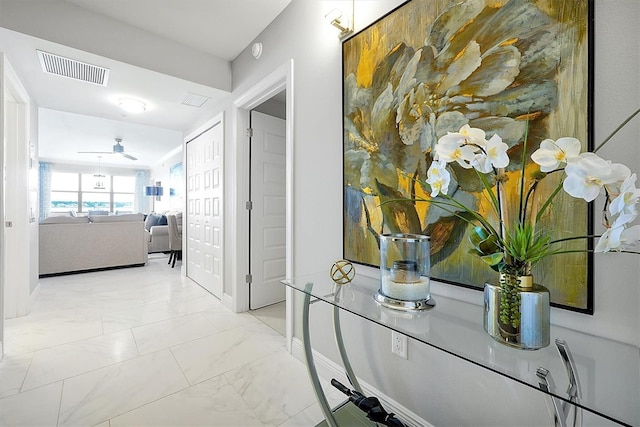 16300 County Road 455 Unit 202, Montverde, FL 34756 - hall featuring marble look tiles and baseboards