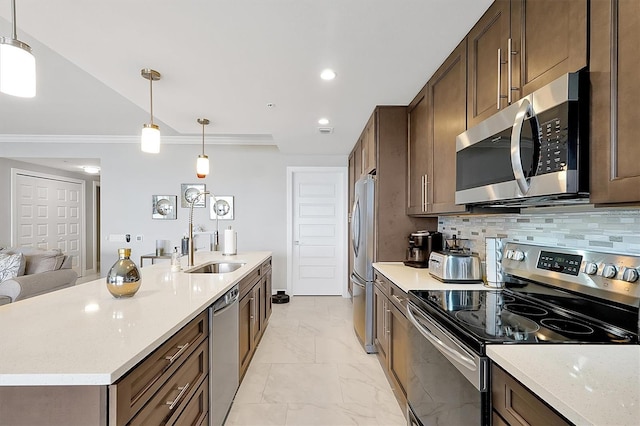 16300 County Road 455 Unit 202, Montverde, FL 34756 - kitchen featuring stainless steel appliances, ornamental molding, a sink, decorative light fixtures, and backsplash