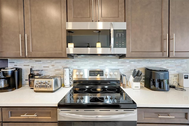 16300 County Road 455 Unit 202, Montverde, FL 34756 - kitchen featuring appliances with stainless steel finishes, light countertops, and tasteful backsplash