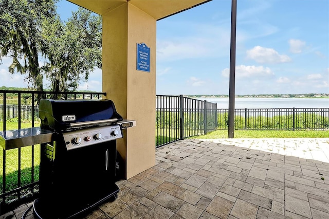 16300 County Road 455 Unit 202, Montverde, FL 34756 - view of patio / terrace with area for grilling and a water view