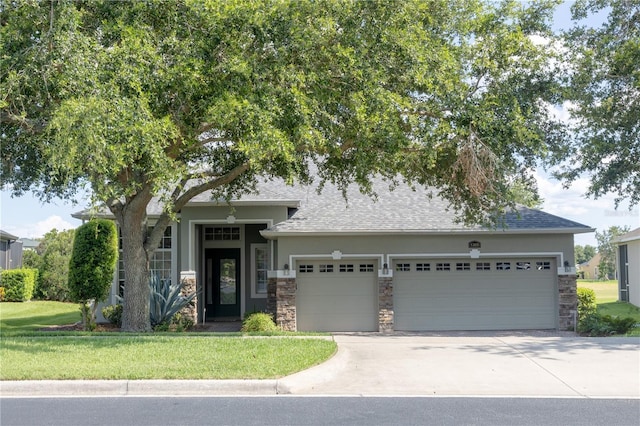 1355 Misty Glen Ln, Clermont, FL 34711 - view of front of home featuring an attached garage, stone siding, driveway, roof with shingles, and a front lawn