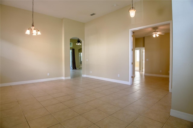 1355 Misty Glen Ln, Clermont, FL 34711 - unfurnished room with ceiling fan, arched walkways, light tile patterned floors, and a chandelier