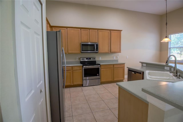 1355 Misty Glen Ln, Clermont, FL 34711 - kitchen with appliances with stainless steel finishes, light tile patterned floors, hanging light fixtures, and light countertops