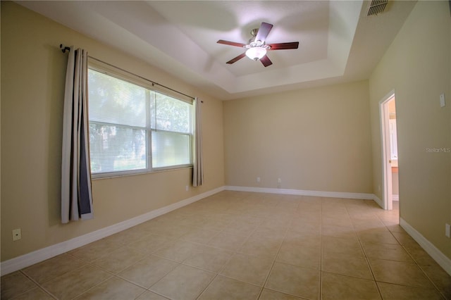 1355 Misty Glen Ln, Clermont, FL 34711 - empty room featuring a ceiling fan, a tray ceiling, and light tile patterned floors