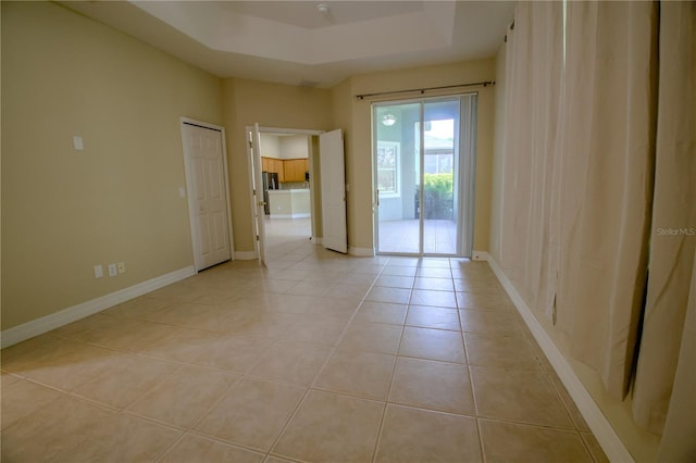 1355 Misty Glen Ln, Clermont, FL 34711 - empty room with light tile patterned flooring and a raised ceiling