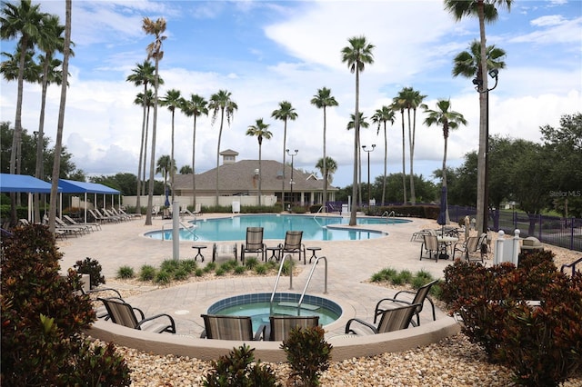 1355 Misty Glen Ln, Clermont, FL 34711 - community pool featuring a hot tub and a patio area