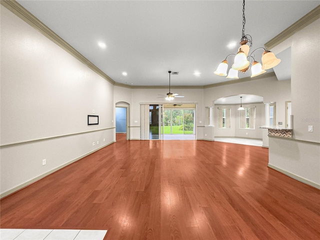 8045 Waterbury Way, Mount Dora, FL 32757 - unfurnished living room with arched walkways, a chandelier, ornamental molding, wood finished floors, and a ceiling fan
