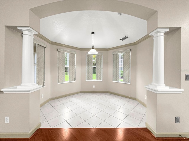 8045 Waterbury Way, Mount Dora, FL 32757 - unfurnished dining area with ornate columns and ornamental molding