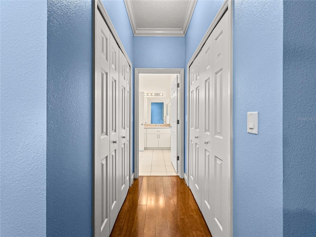 8045 Waterbury Way, Mount Dora, FL 32757 - hall featuring crown molding, a textured wall, and dark wood-type flooring