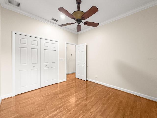 8045 Waterbury Way, Mount Dora, FL 32757 - unfurnished bedroom featuring ornamental molding, light wood-type flooring, a closet, and a ceiling fan