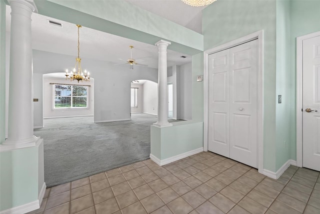 206 Palermo Pl, Lady Lake, FL 32159 - carpeted foyer featuring a ceiling fan, tile patterned floors, decorative columns, and a chandelier