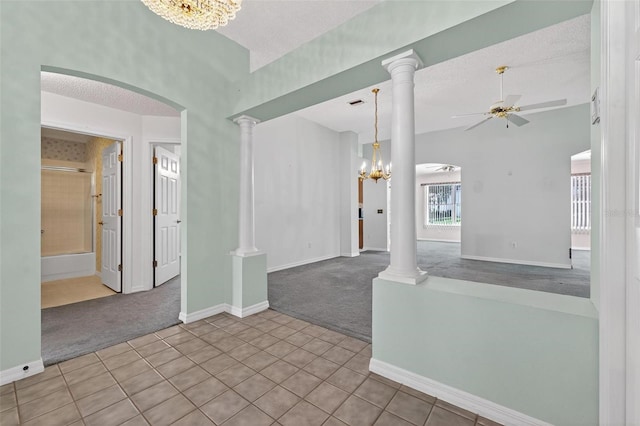 206 Palermo Pl, Lady Lake, FL 32159 - carpeted spare room with tile patterned flooring, a ceiling fan, a chandelier, a textured ceiling, and arched walkways