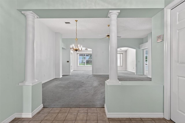 206 Palermo Pl, Lady Lake, FL 32159 - carpeted foyer entrance with a ceiling fan, tile patterned floors, a chandelier, arched walkways, and ornate columns